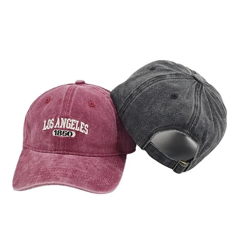 Adult personalised embroidered peaked cap in beige with adjustable strap and distressed lettering.