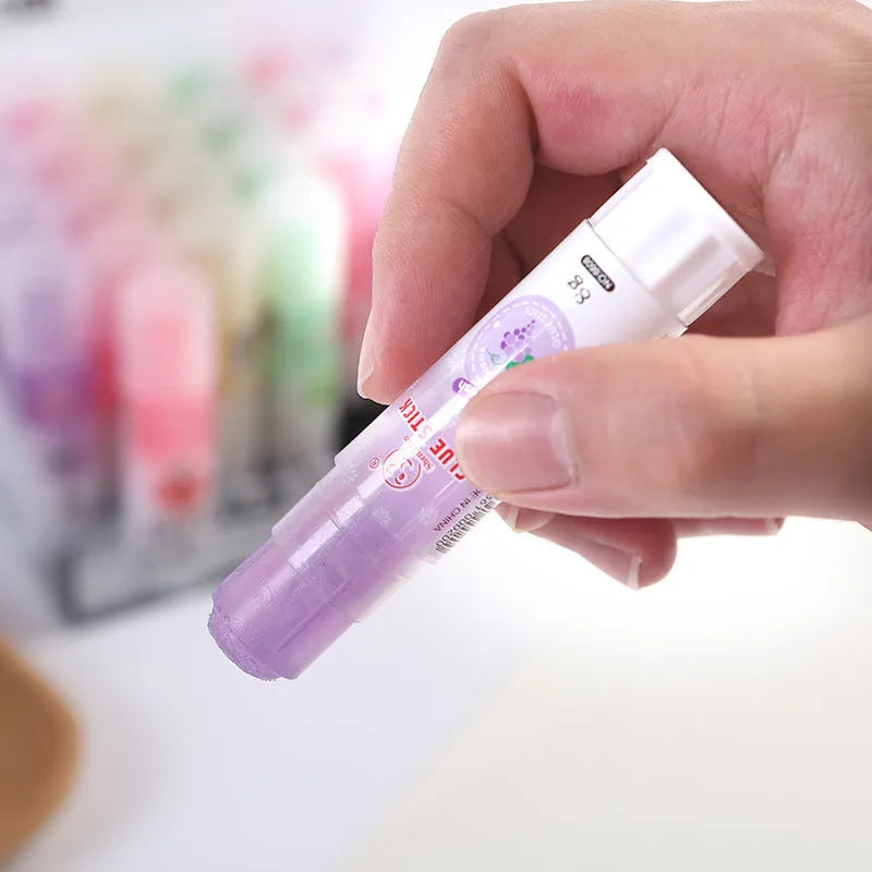 Jelly fruit fragrance solid glue stick 8.5cm long with random colour barrel on white background