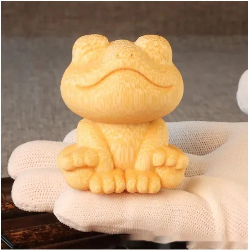Solid bamboo carving ornament of smiling frog design measuring 5cm height and 4.5cm diameter
