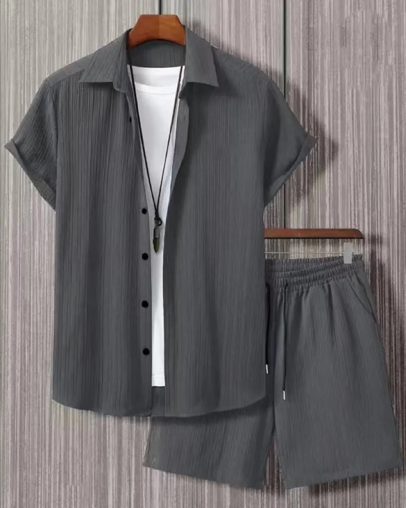 Man wearing a beige short sleeve jacquard suit shirt with matching shorts from a two-piece set.