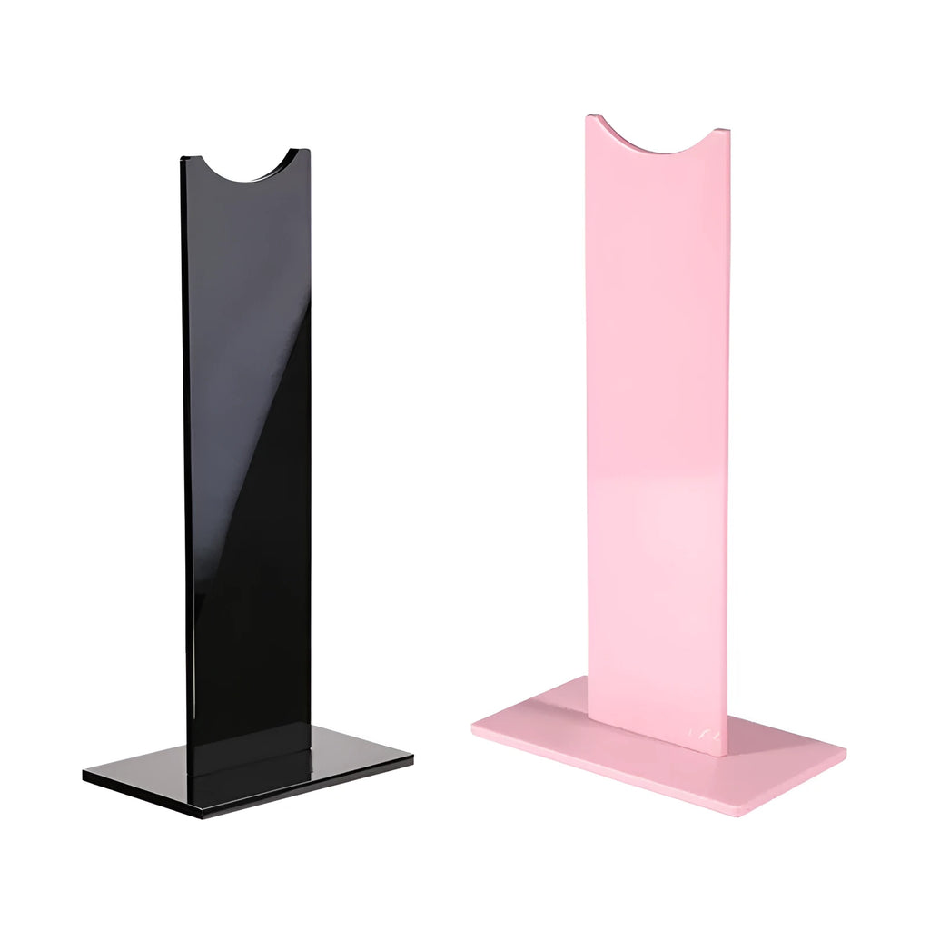 Pink and black detachable headset bracket with a non-slip silicone base on a desk