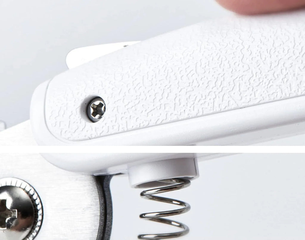 White pet nail clippers with LED light, anti-splash guard, and a nail file on a table.