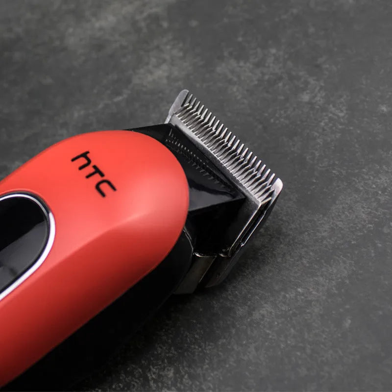 Professional digital hair clipper in black, red, or white with charger, combs, and maintenance tools.