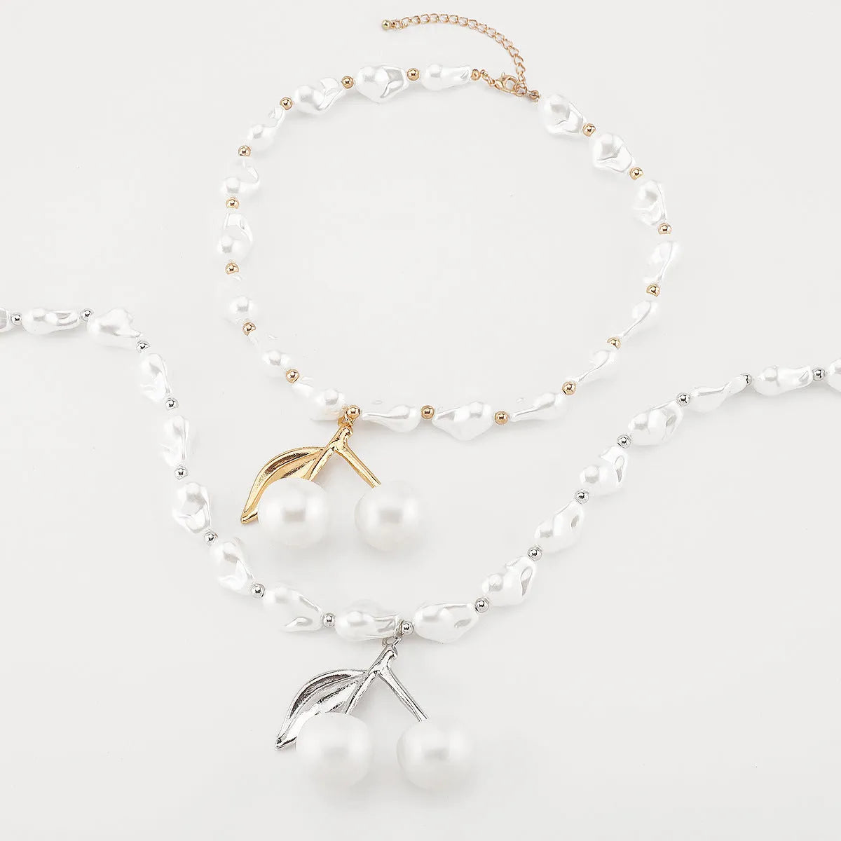 Women's geometric cherry fruit pendant necklace with pearl chain in gold or white K electroplated finish