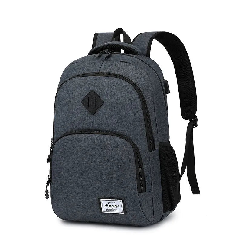 Gray nylon backpack with USB charging port and trolley sleeve on a suitcase.