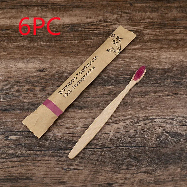 Set of ten bamboo toothbrushes with charcoal-infused bristles in assorted colours on a white background.