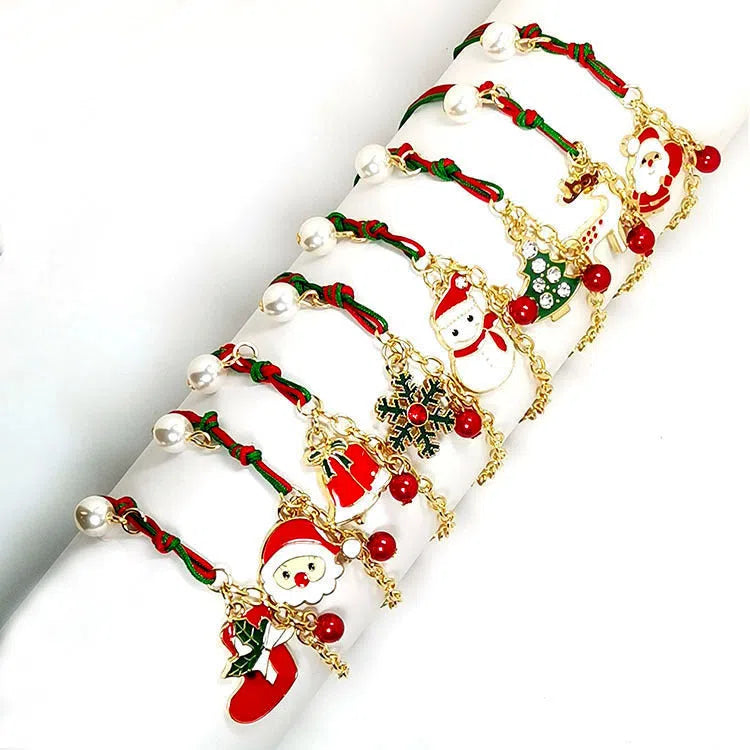 Christmas charm bracelet with alloy chain and festive pendant charms on light background