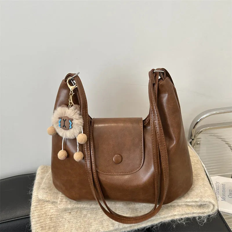 Women's PU leather shoulder bag in horizontal square shape with single strap, showing interior mobile phone compartment