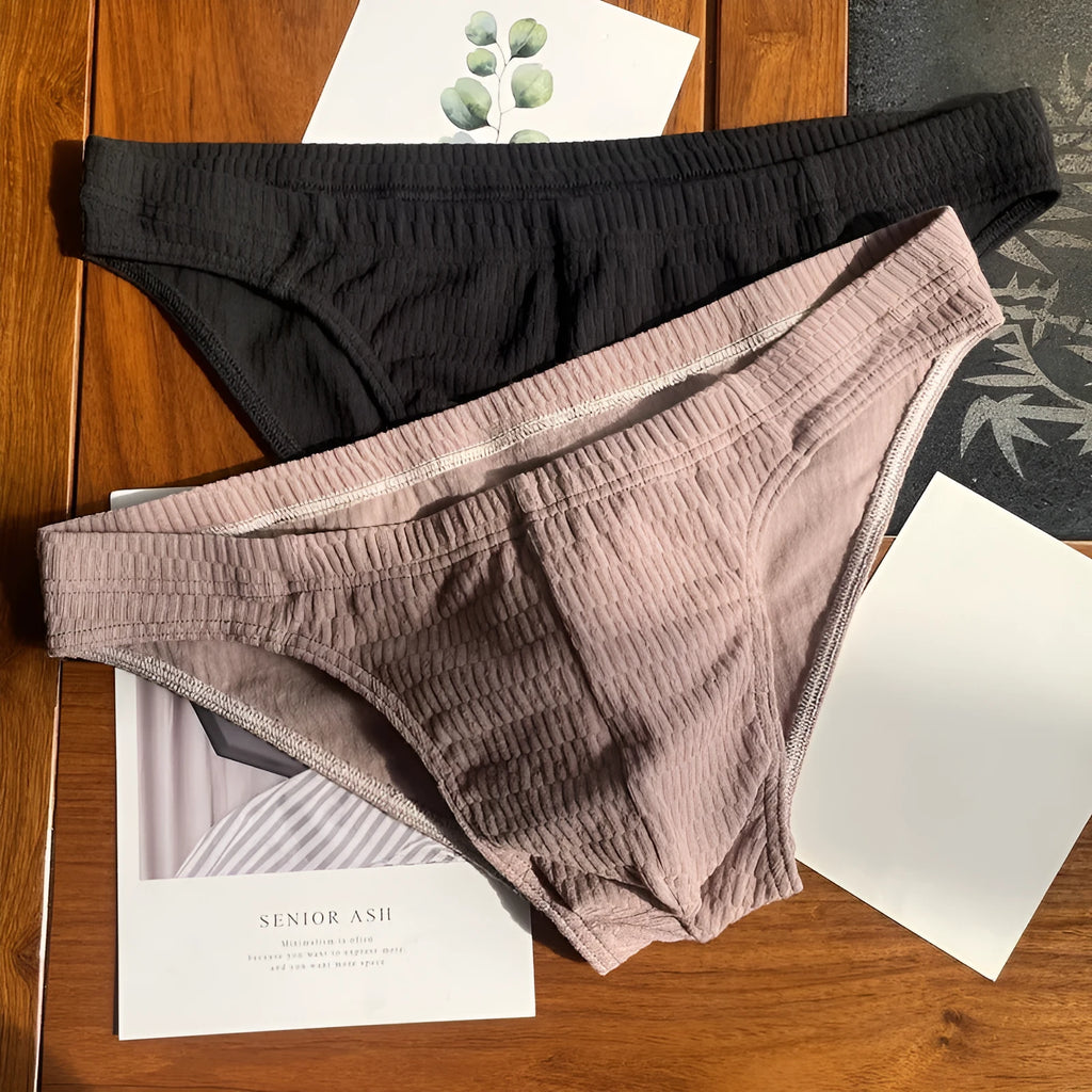 Men's solid colour cotton triangle briefs in mid-waist style, shown in apricot and black colour options.