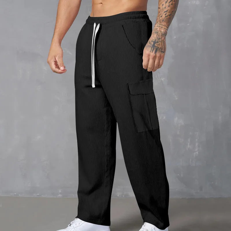Men's loose-fitting corduroy cargo trousers in navy blue with straight wide-leg cut and elasticated waist