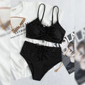 Black high-waisted bikini swimsuit for women with sleeveless top and shorts on a neutral background.