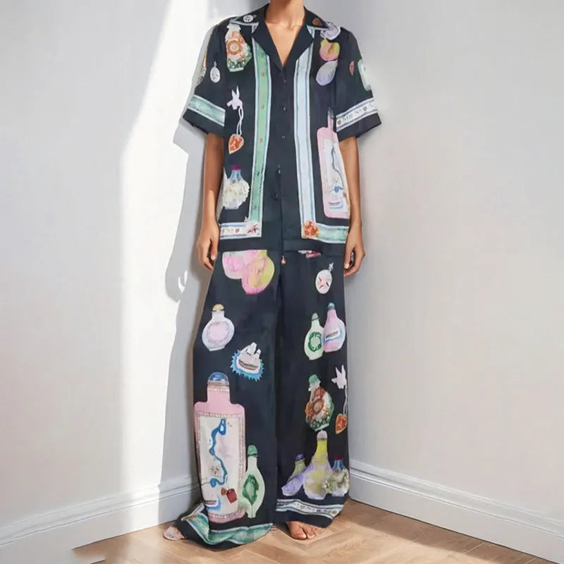 Black women's pyjama set with cartoon print pattern showing matching trousers and top
