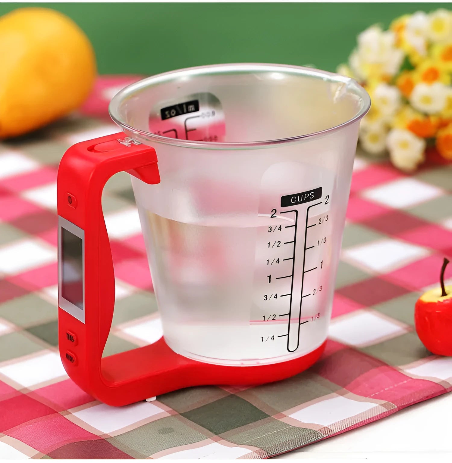 Green electronic kitchen scale measuring cup with digital LCD display on handle.