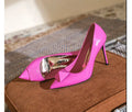 Pink women's pointed toe stiletto high heels with patent leather upper, rivet details, and a buckle.
