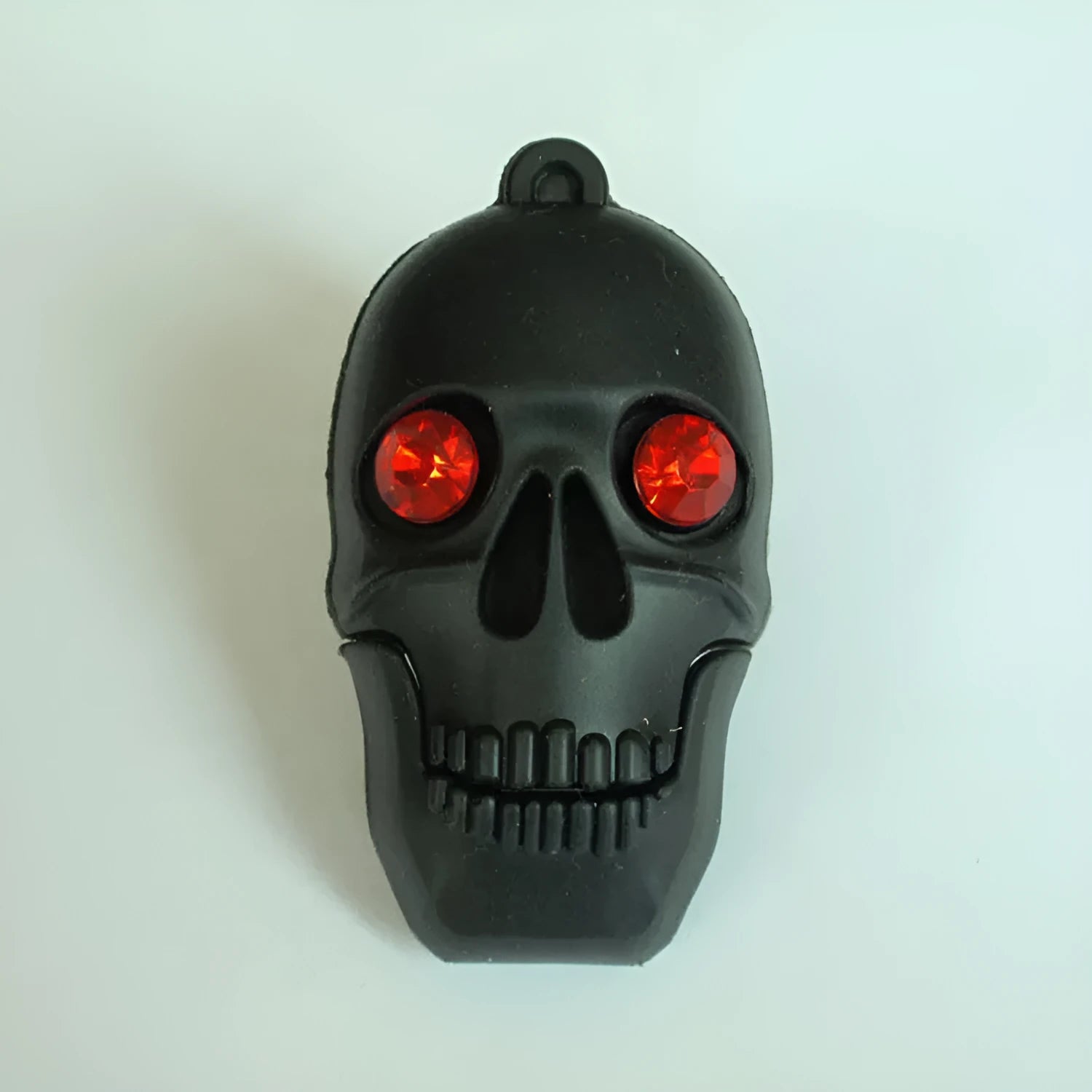 Halloween-themed skeleton skull USB flash drive with small chain in assorted colours.