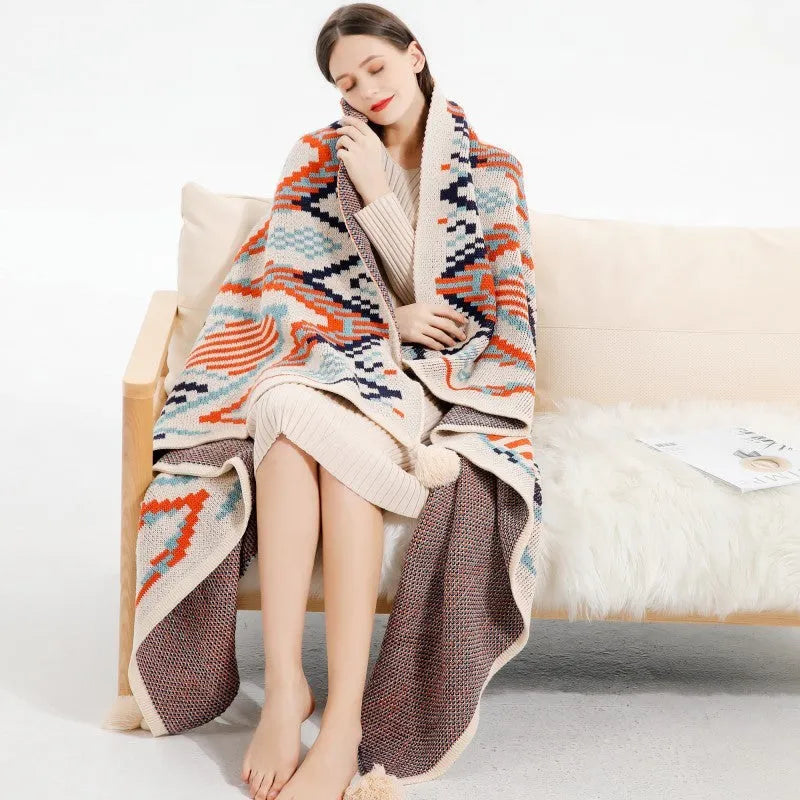 Acrylic sofa blanket with tassels in geometric pattern colour option on a sofa
