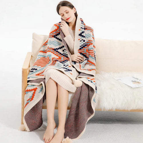 Acrylic sofa blanket with tassels in geometric pattern colour option on a sofa