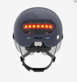 Cycling helmet with built-in red LED brake tail light on the back, shown in sizes M and L.