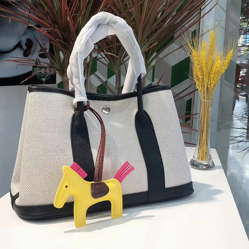 Genuine leather women's crossbody tote bag with canvas texture in bucket shape