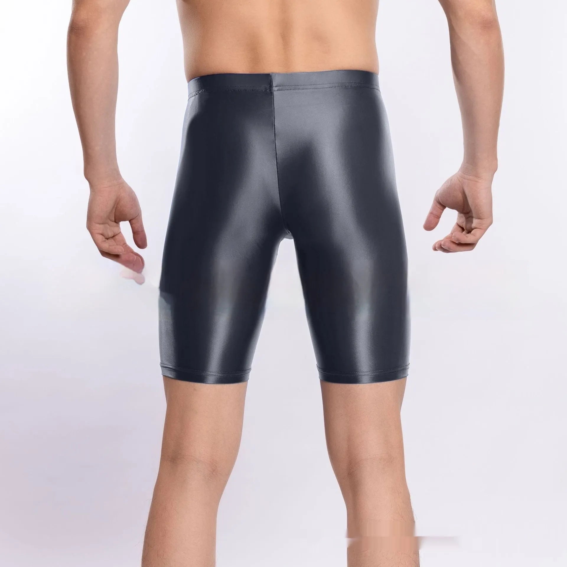 Man wearing shiny black plus size nylon sports shorts, showing silky finish.