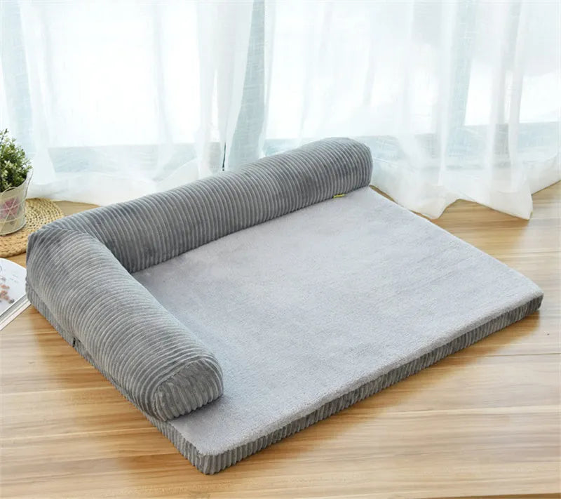 Corduroy bolster dog bed in grey, showing bilateral raised sides and non-slip base.