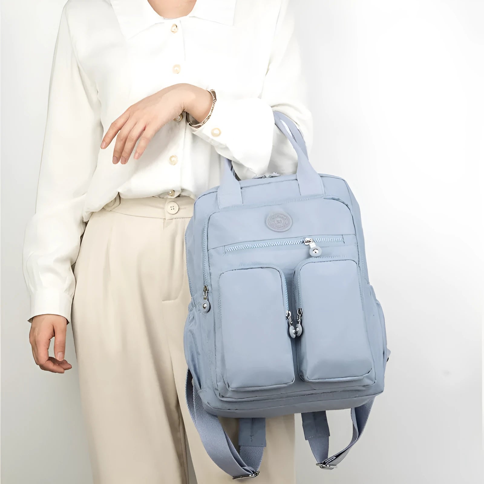 Waterproof women's large capacity nylon travel backpack in multiple colours showing internal laptop compartment and pockets.