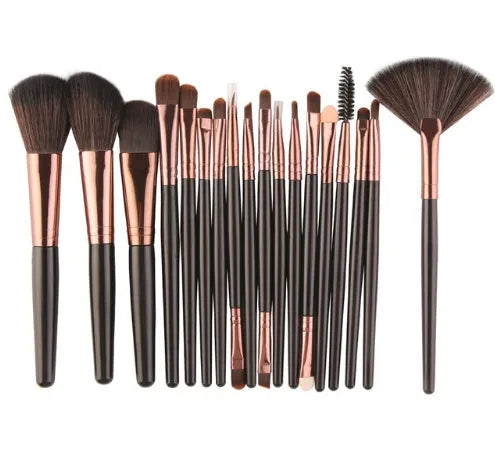 18-piece makeup brush set with fan brushes arranged on a table.