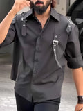Black men's utility style button-up shirt with regular fit on a mannequin.