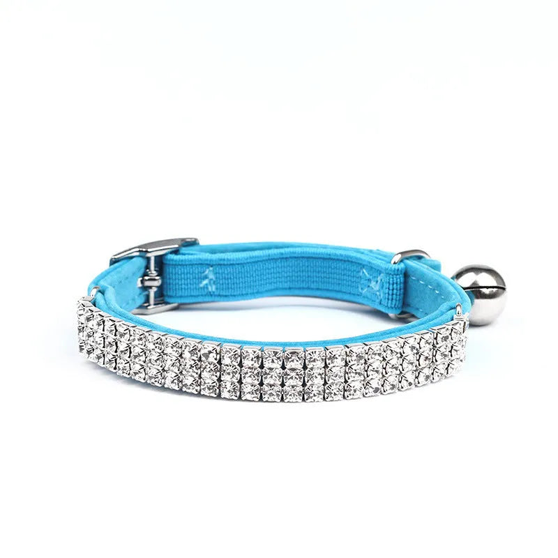 A red velvet cat collar with rhinestones on an adjustable band.