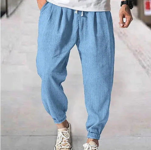 Men's casual cotton trousers with banded ankles in light green colour showing loose fit summer style