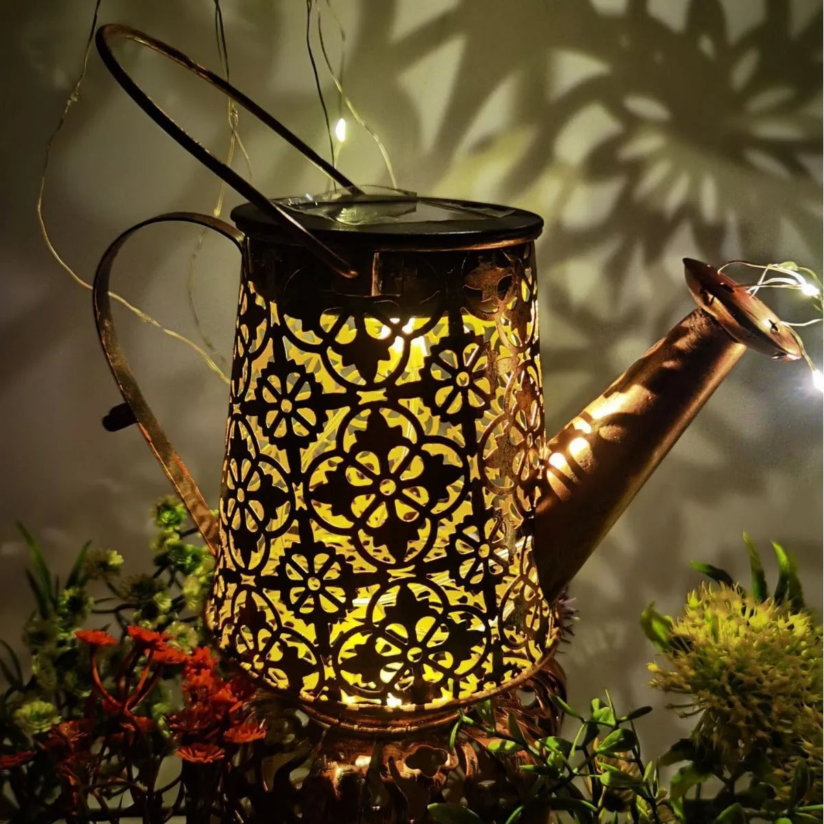 Solar-powered butterfly kettle garden light with wrought iron construction and solar panel