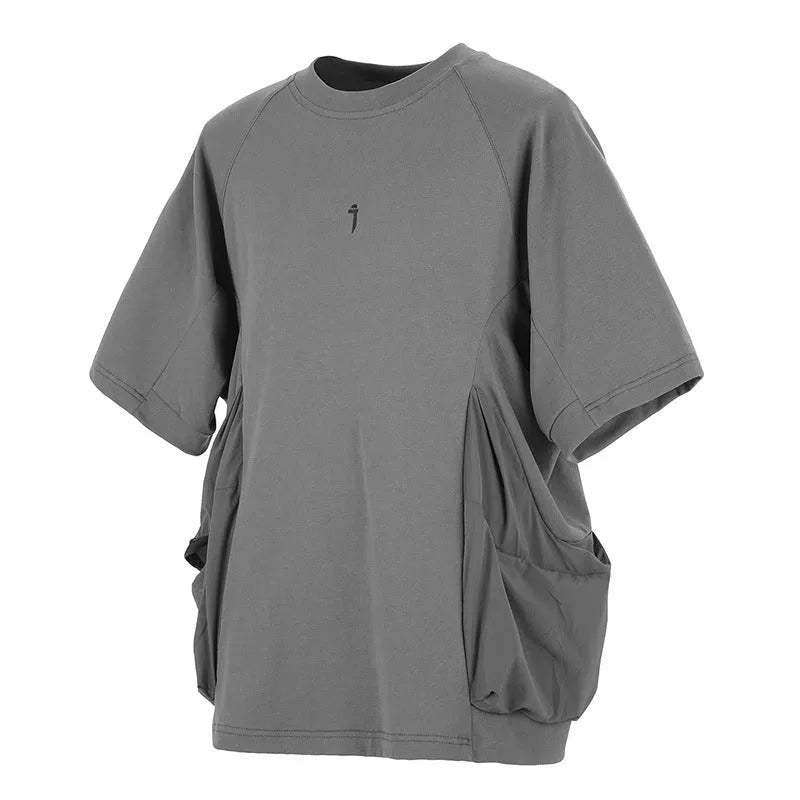 Men's loose fit grey cotton t-shirt with big chest pockets, short sleeves, and a round neck.