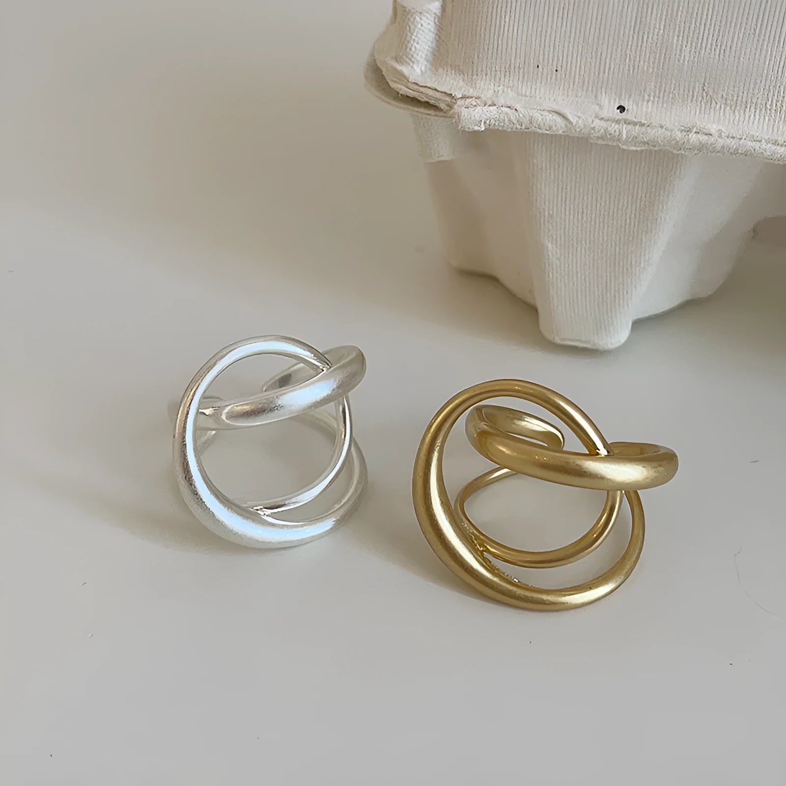 Geometric open ring with interlaced matte metal design in gold or silver electroplated finish