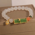 Women's white agate jade bracelet with bamboo joint beads on a wrist.