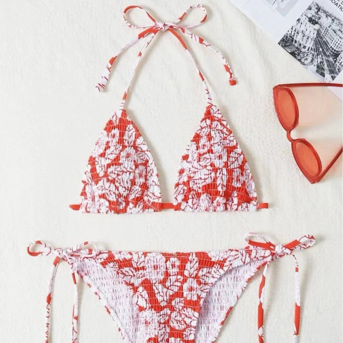 Women's floral print halter neck swimsuit briefs in light blue on a mannequin.