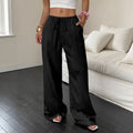 Women's black wide-leg trousers with a white lace-up detail at the mid waist on a hanger.