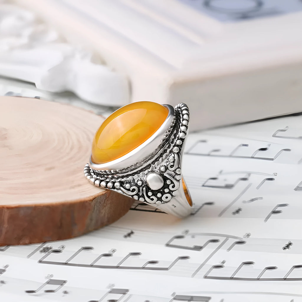 Geometric antique silver ring with fluorescent beeswax amber centre in retro style