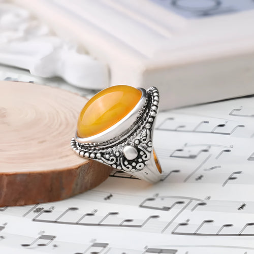 Geometric antique silver ring with fluorescent beeswax amber centre in retro style