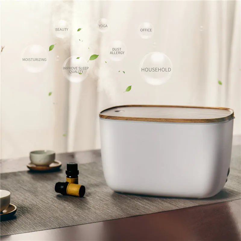 GX-22K white household atomiser humidifier and diffuser with night light on a wooden table.