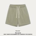 Loose cotton denim shorts for baby boy or girl in charcoal grey colour on a hanger