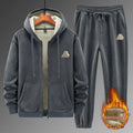 Man wearing a grey hooded sweater and matching trousers from a casual sports suit set.