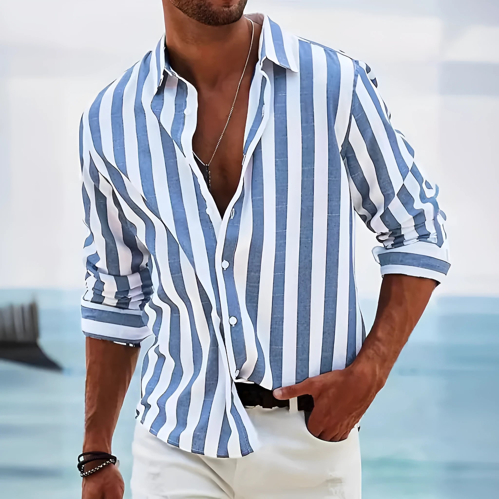 Man wearing a grey and white striped loose-fit long-sleeved casual shirt