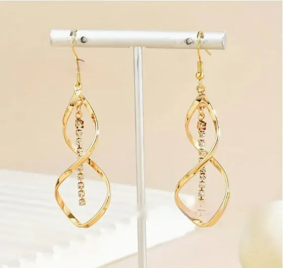 Gold spiral design alloy earrings with geometric ellipse shape