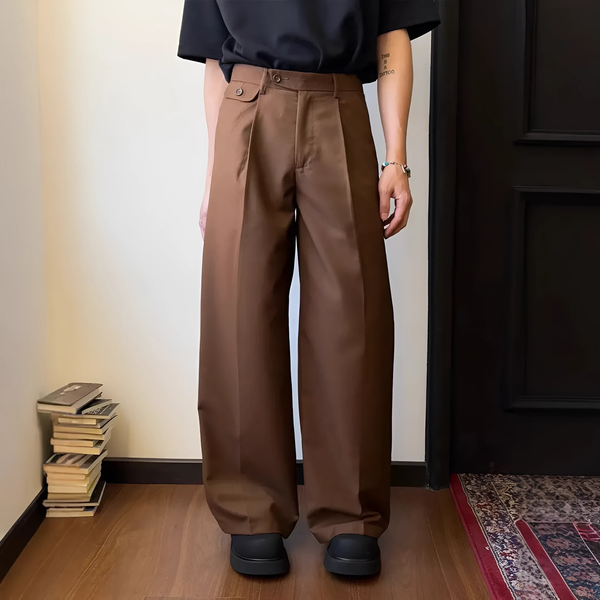 Men's straight-leg loose-fit trousers in brown and black colours on a hanger.
