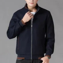 Men's grey polyester fleece jacket with long sleeves and a stick pocket, shown on a hanger.