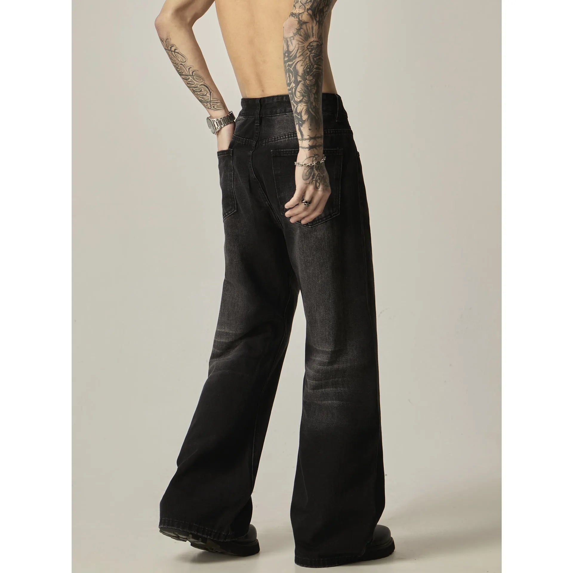 Black loose straight jeans with retro styling and zipper fly in polyester denim fabric