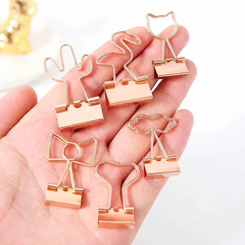 Gold-plated decorative binder clips showing flamingo, love, clouds, cat, cactus and bow designs