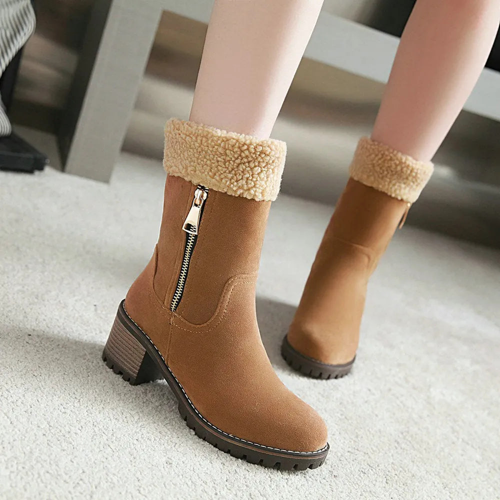 A pair of snow boots with a rubber sole and plush lining on a winter background.
