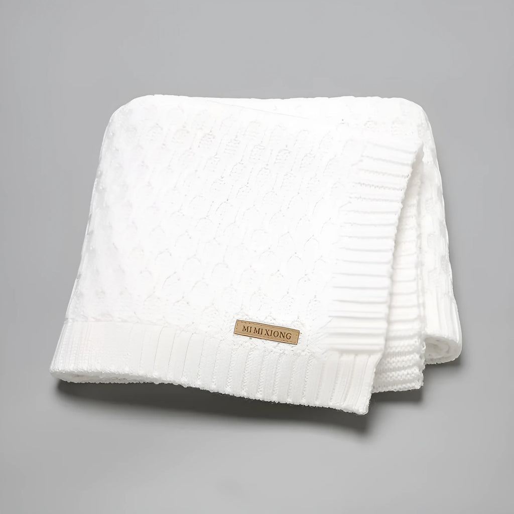 Solid colour acrylic infant hug blanket with textured lines, shown in beige khaki colour.