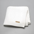 Solid colour acrylic infant hug blanket with textured lines, shown in beige khaki colour.